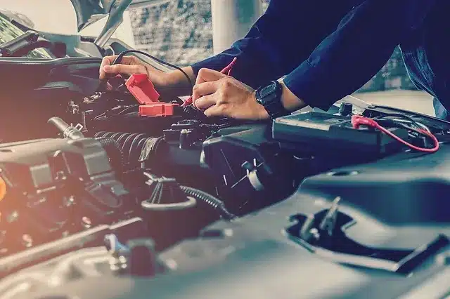 Expert technician performing a battery replacement at Limitless Tire